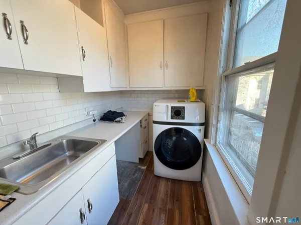 a kitchen with a sink a washer and dryer