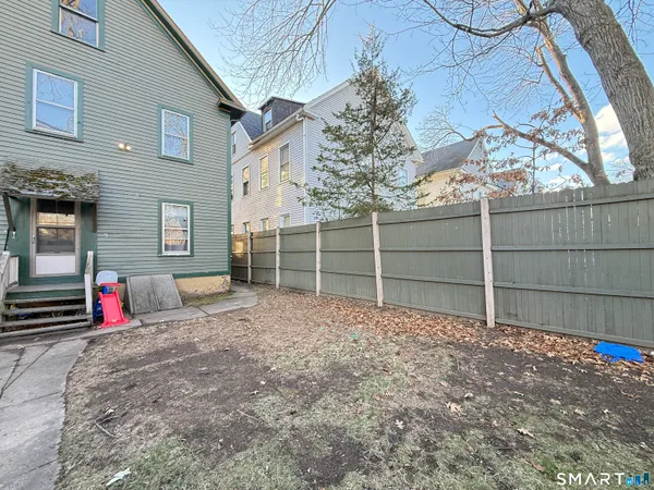 a view of the house with a yard