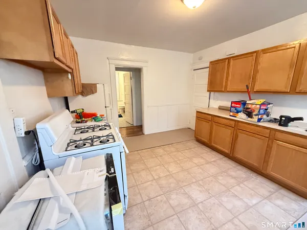 a kitchen with stainless steel appliances a sink stove and cabinets