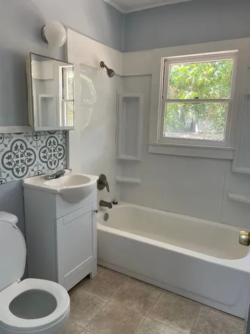 a bathroom with a toilet bathtub and sink