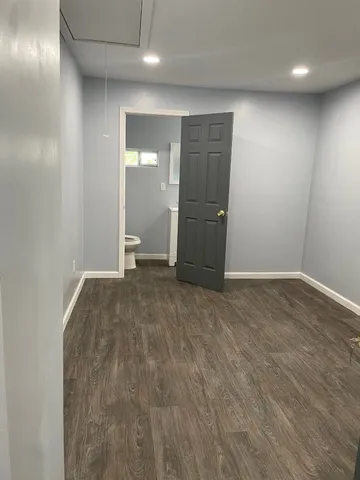 an empty room with closet and bathroom