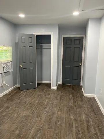 an empty room with closet and a bathroom