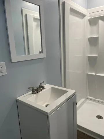 a utility room with a sink and a mirror