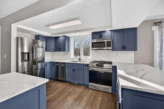 a living room with couches and a flat screen tv