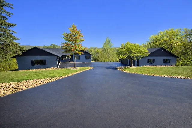 a open kitchen with granite countertop a stove top oven a sink dishwasher and a fireplace with wooden floor