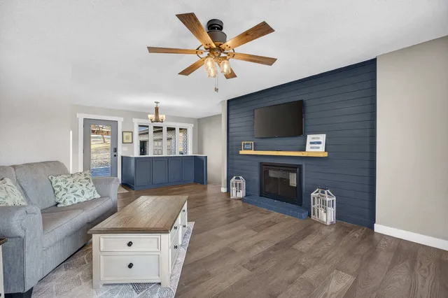 a spacious bedroom with a bed and lamp on desk