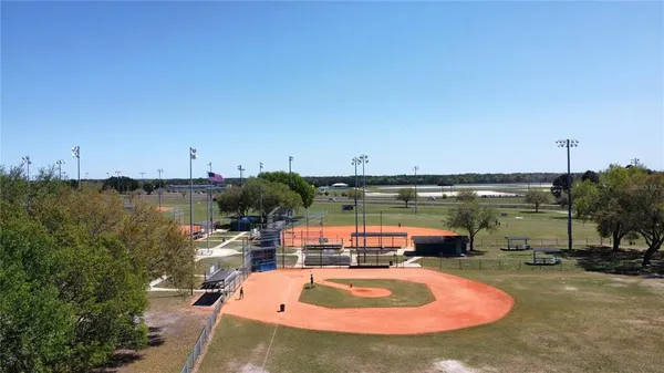 a swimming pool with outdoor seating and yard