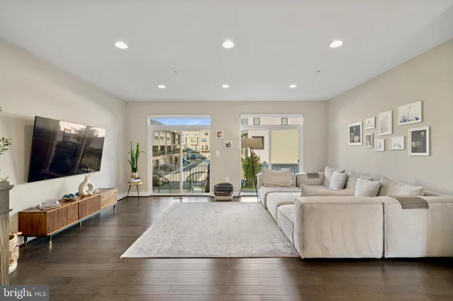 a dining room with wooden floor a chandelier a wooden table and chairs