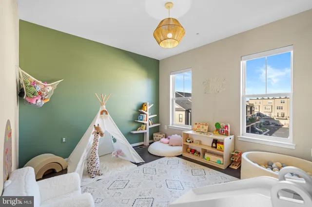 a spacious bedroom with a bed and a chandelier