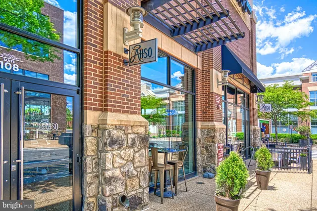 a view of a fountain in front of a house with a big yard