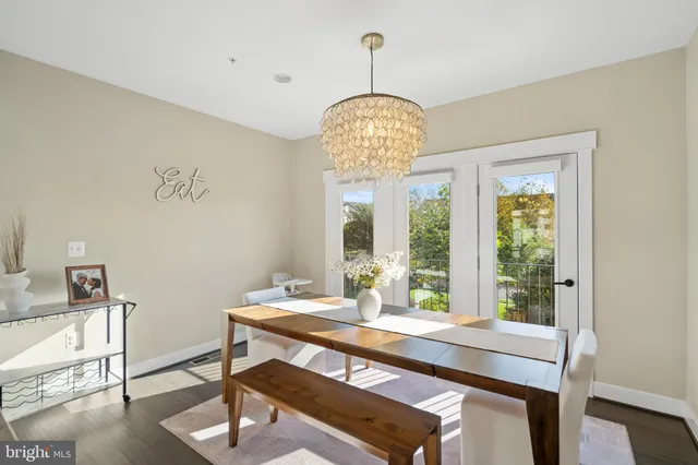 a kitchen with stainless steel appliances kitchen island granite countertop a stove a sink dishwasher and a refrigerator with wooden floor