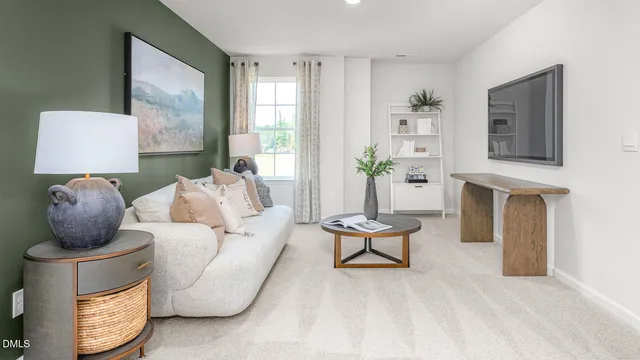 a living room with furniture and a potted plant