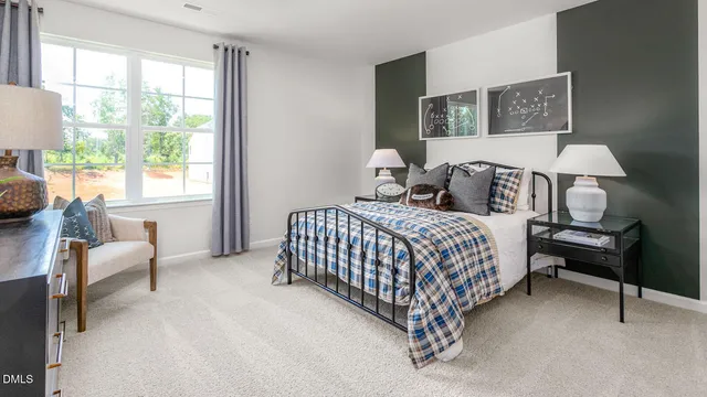 a bedroom with a bed a window and dresser