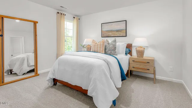 a bedroom with a bed and a lamp on table