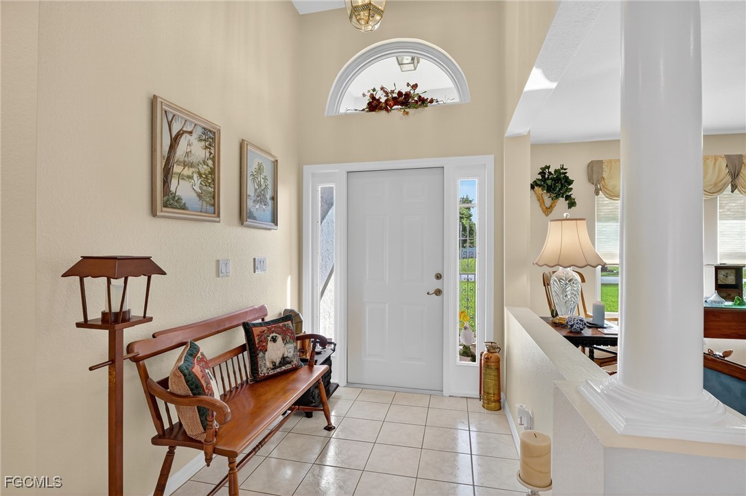 4306 Southwest 3rd Avenue Cape Coral, FL 33914 - Photo 4 of 50 a view of a hallway with entryway dining room and hall with wooden floor