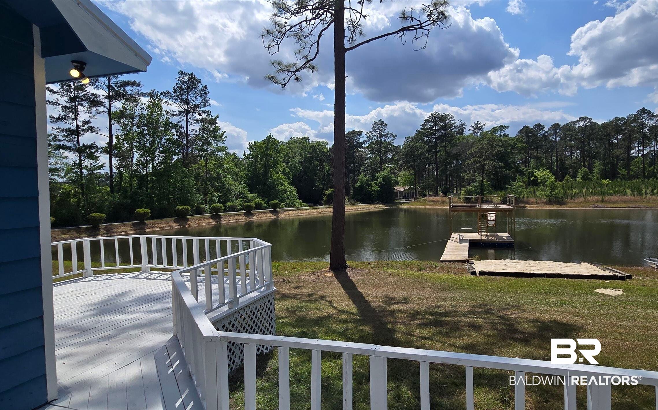 3160 Old Castleberry Road Brewton, AL 36426 - Photo 32 of 36 Expansive deck with white railing overlooking a substantial body of water