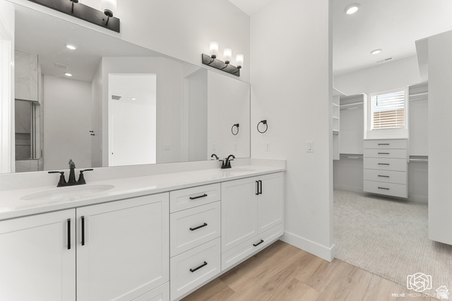 707 Spring Lily Drive St. George, UT 84790 - Photo 24 of 43 Dual vanity with white cabinetry and black hardware