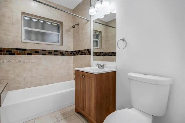 a bathroom with a sink a toilet and bathtub