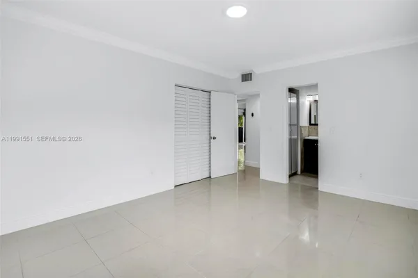 a view of an empty room with closet