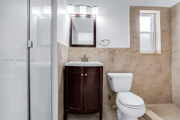 a bathroom with a toilet sink and mirror