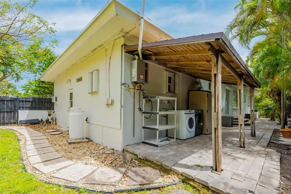 a view of a chair and tables in the patio