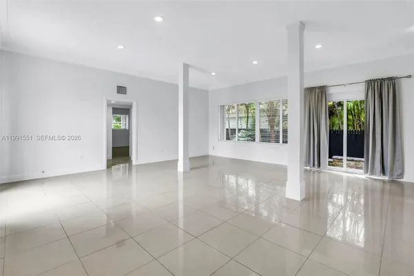 an empty room with windows and entrance