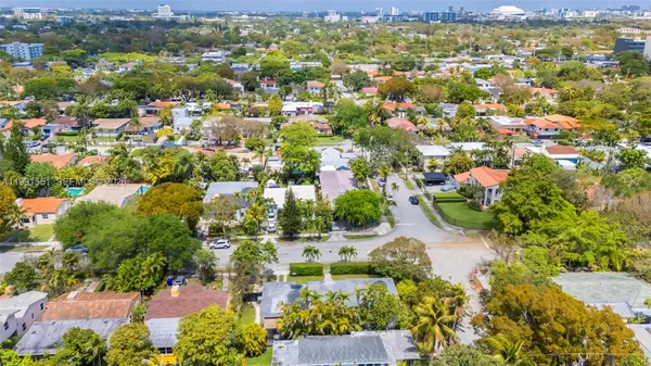 an aerial view of a house with a yard and a outdoor space