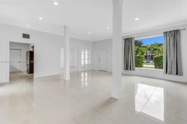 an empty room with windows and entrance