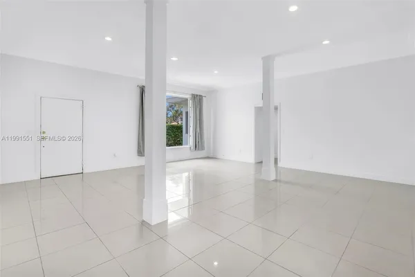 an empty room with white walls and entryway