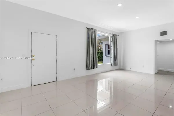 an empty room with windows and closet