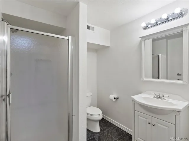 a spacious bathroom with a double vanity sink and a mirror