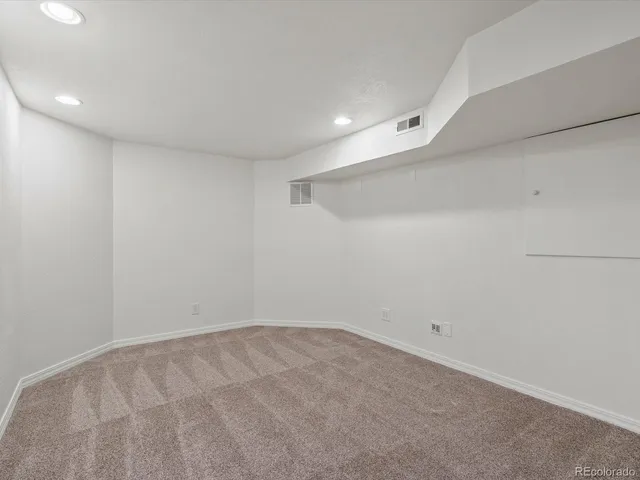 a view of a house with a yard and a large tree