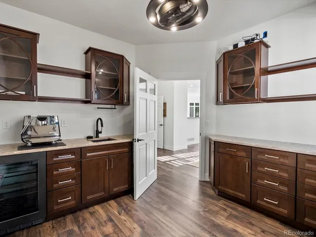 a front view of a house with a garden and trees