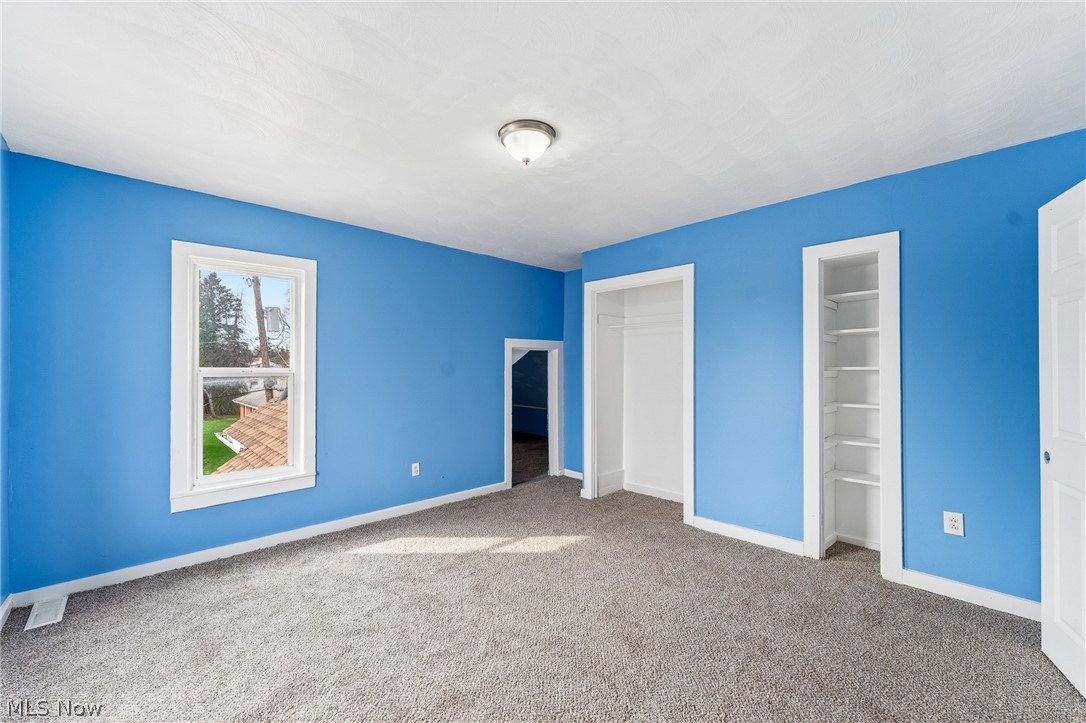 563 Geneva Avenue Struthers, OH 44471 - Photo 14 of 31 Unfurnished bedroom with multiple closets and light colored carpet
