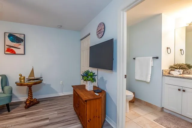 a view of a workspace with furniture and wooden floor