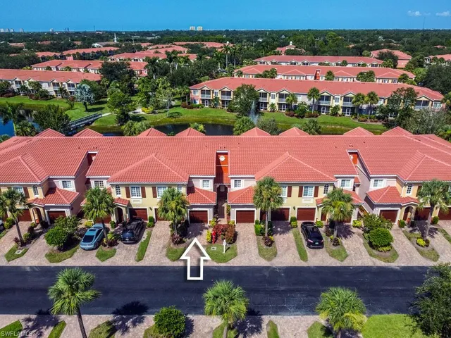an aerial view of residential houses and lake
