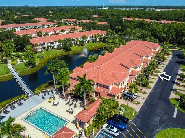an aerial view of a house with a garden and lake view