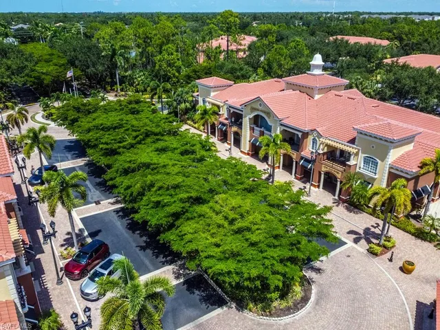 an aerial view of multiple houses with yard