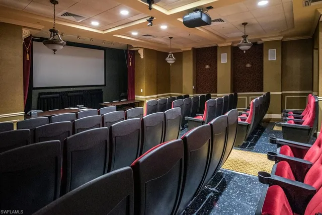 a media room with lots of chairs and a projector screen