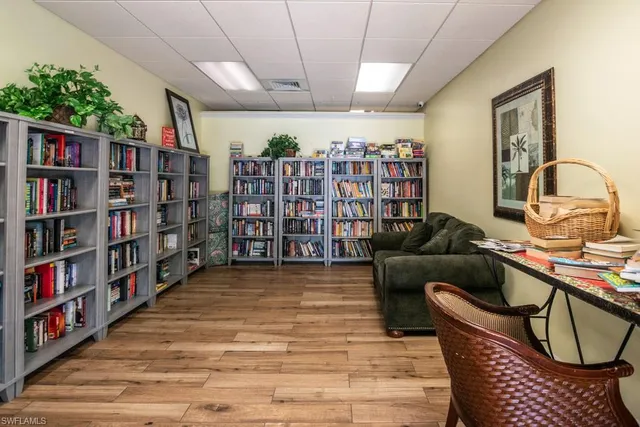 a living room with lots of furniture and a book shelf