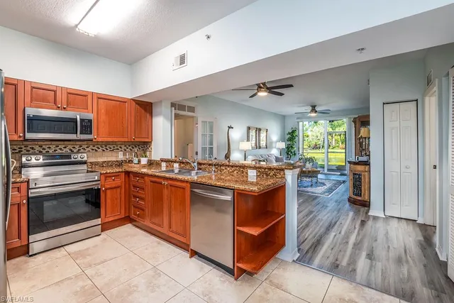 a kitchen with stainless steel appliances granite countertop a stove and a sink