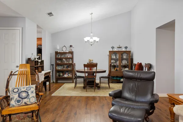 a dining room with furniture and wooden floor
