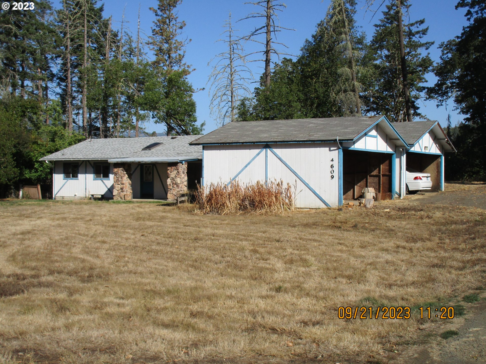 4609 Melrose Road Roseburg, OR 97471 - Photo 1 of 17 a view of a house with a yard and sitting area