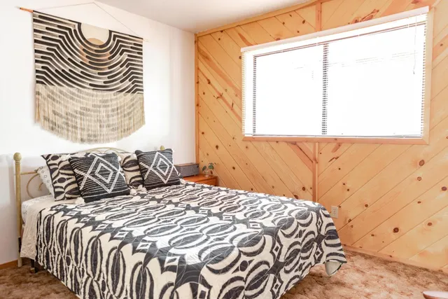 a bedroom with a bed and a window