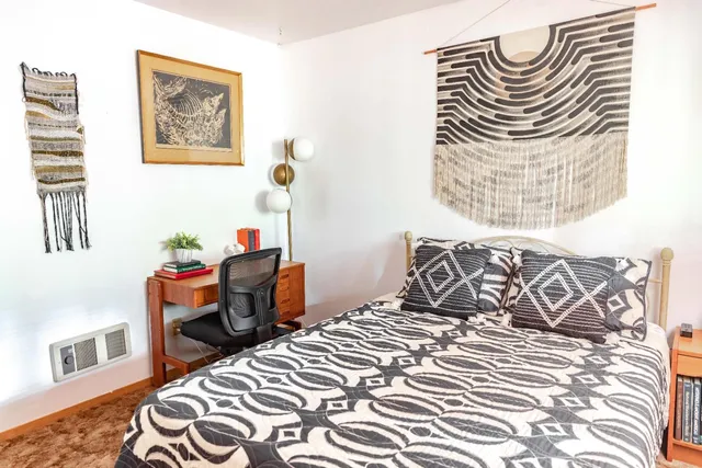 a bedroom with a bed and dresser