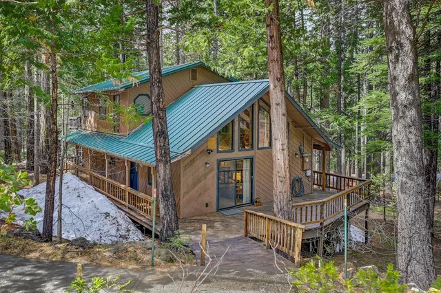a view of house with a yard and balcony