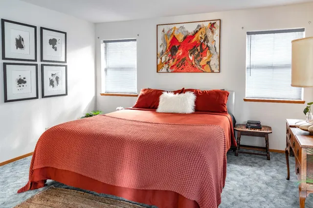 a bedroom with furniture and a large window