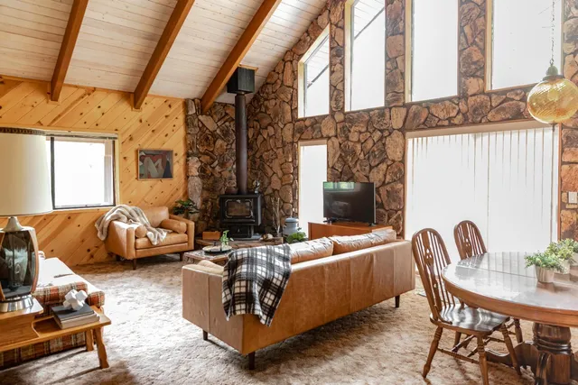 a bedroom with furniture and a large window