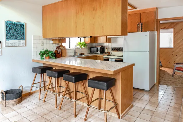 a kitchen with stainless steel appliances a refrigerator and a stove top oven