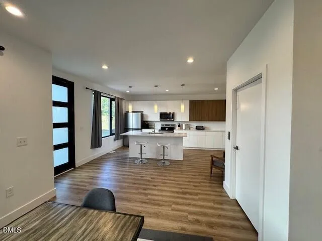 a living room with furniture and a kitchen view
